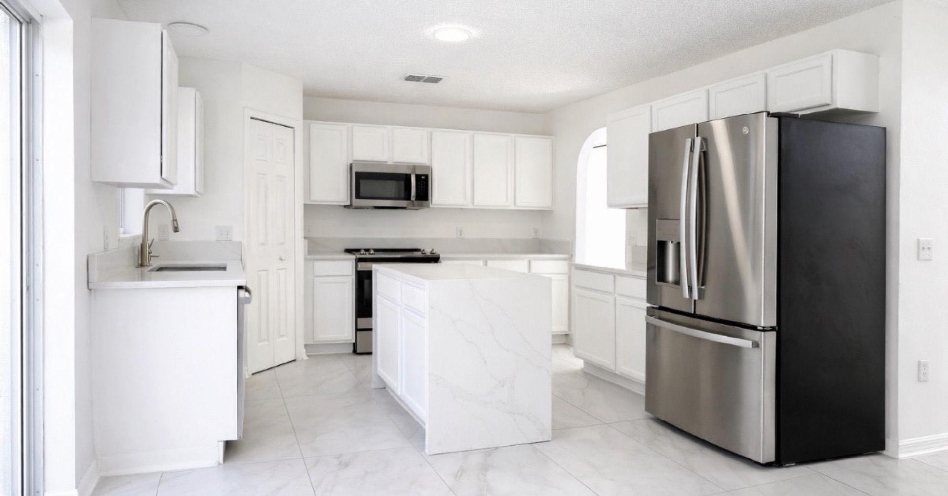 White kitchen with marble island