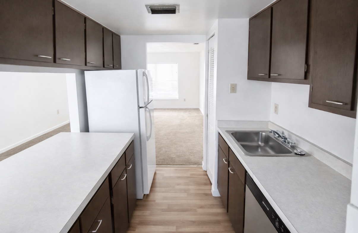 Galley kitchen with dark cabinets